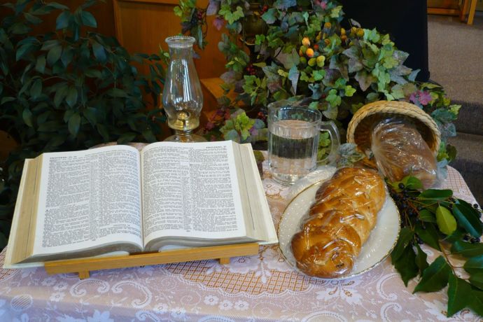 Bible, lantern, communion elements on table