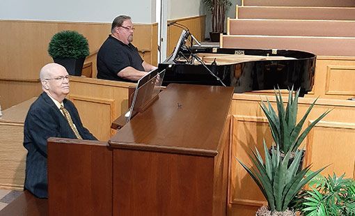 Organist and pianist at work playing organ & piano