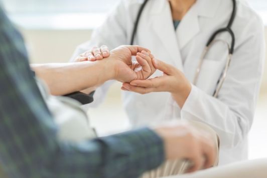 Doctor assessing a patients hand