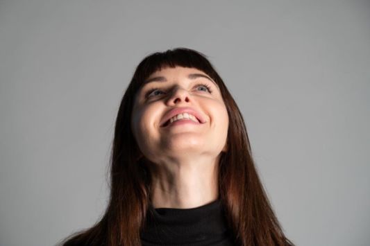 Young woman smiling and looking up