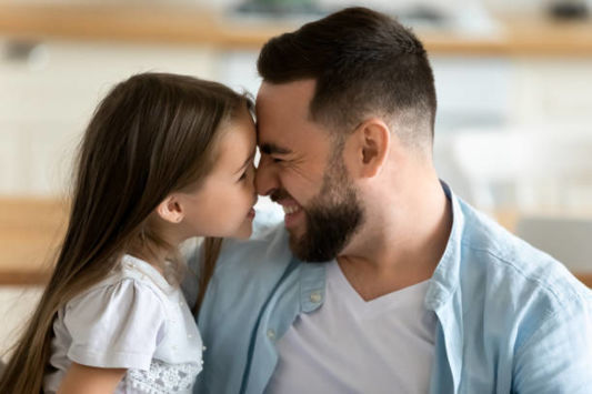 Father and child nose to nose smiling